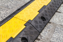 Cable Protector Cover. Yellow And Black Protective Cable Ramp For Outdoor Events.