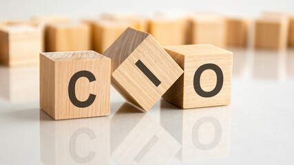 Sticker - three wooden blocks with the letters CIO on the bright surface of a gray table, business concept