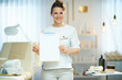 smiling woman worker in beauty studio showing blank clipboard