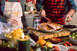 © karepa - father and daughter celebrating Christmas in the kitchen cooking christmas duck or Goose