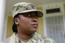 Close Up Of Military Woman In Camouflage Uniform In Front Of House, African American