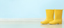 Rubber Rain Boots On Color Background With Space For Text