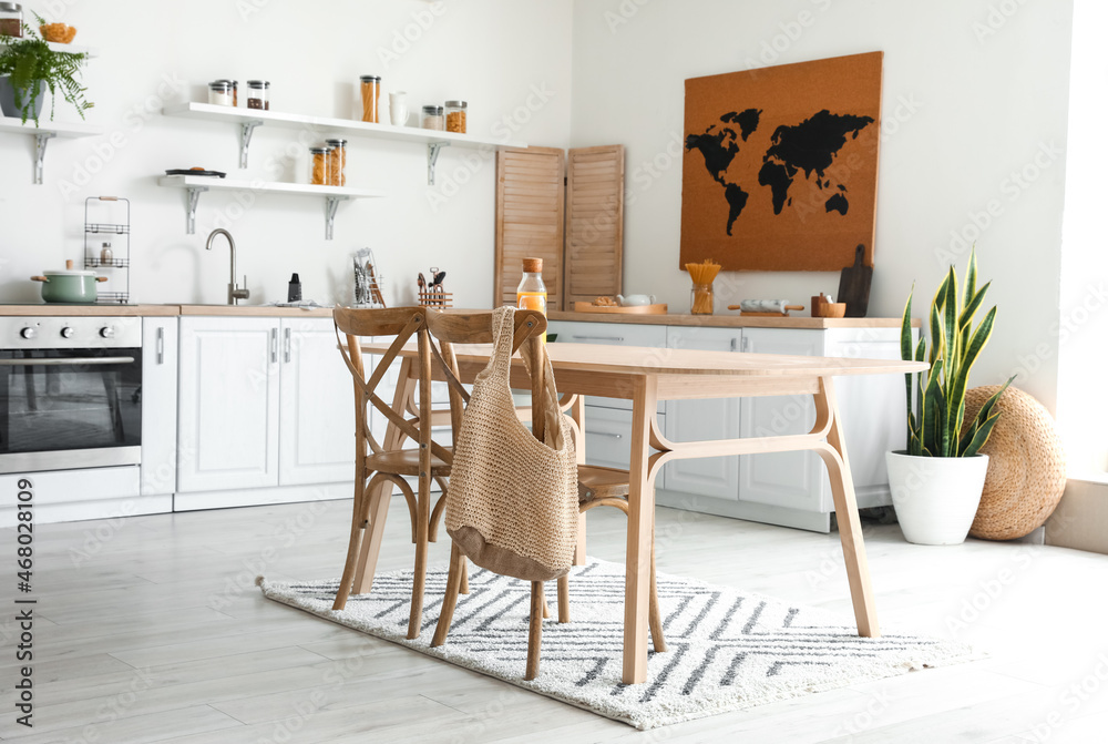Stylish kitchen interior with wooden dining table
