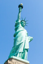 Low Angle View Of Statue Of Liberty With Blue Sky During Sunny Day In Summer. Liberty Island, New York. United States.