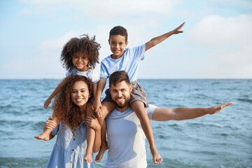 Wall Mural - Happy family on sea beach