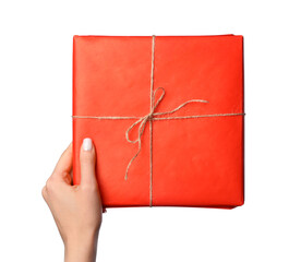 Woman holding gift box against white background, closeup