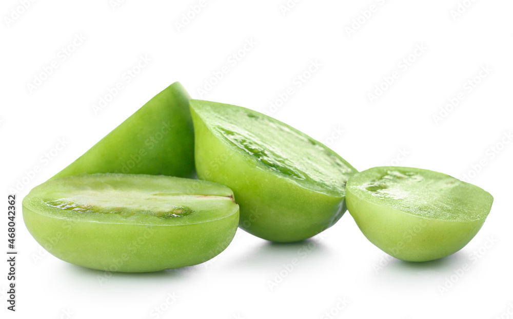 Halves of fresh green tomatoes on white background