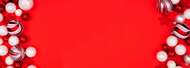 Poster - Christmas double border banner with red and white ornaments. Overhead view on a red paper background with copy space.