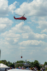 Sticker - Flying red rescue helicopter against a cloudy sky