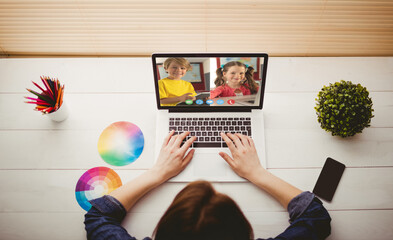 Poster - Caucasian girl using laptop for video call, with smiling elementary school pupils on screen