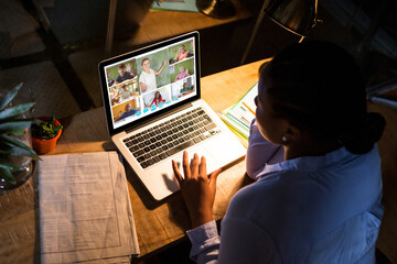 Poster - African american woman using laptop for video call, with diverse elementary school pupils on screen