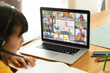 © vectorfusionart - Asian girl using laptop for video call, with smiling diverse elementary school pupils on screen