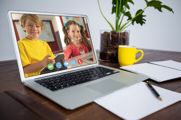 Poster - Smiling caucasian elementary school pupils during class on laptop screen