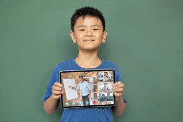 Poster - Smiling asian boy holding tablet for video call, with diverse high school pupils on screen