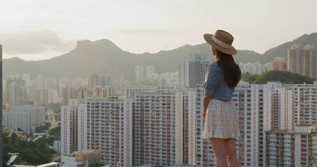 Canvas Print - Woman look at the Hong Kong city at sunset