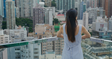 Poster - Woman look at the city in Hong Kong