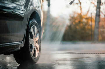 Poster - Manual car wash with white soap, foam on the body. Washing Car Using High Pressure Water.