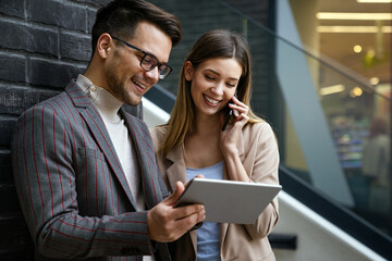 Successful business colleagues people working together on digital devices.