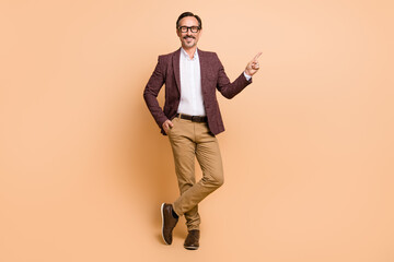 Sticker - Full length body size view of attractive cheery man demonstrating copy space advert offer isolated over beige color background