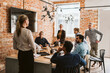 © Maskot - Female entrepreneur discussing strategy with colleagues in board room