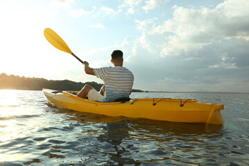 Poster - Handsome man kayaking on river, back view. Summer activity