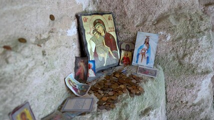 Wall Mural - Offerings left by visitors in Aladzha Orthodox Monastery cave monastery in Bulgaria, 4k video