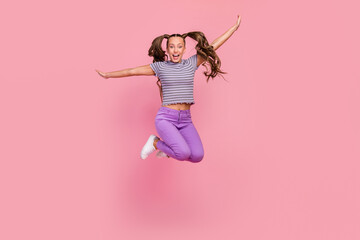 Sticker - Full length body size view of attractive cheerful childish girl jumping having fun fooling isolated over pink color background