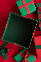 Sticker - Open festive christmas present box on a red background. Flat lay, top view