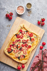 Wall Mural - Puff pastry tart with cherry tomatoes, mozzarella and purple basil