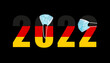 2022 with flag of Germany and medical mask for protection against covid on black background