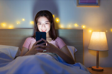 Canvas Print - woman use smartphone on bed