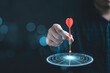 © Dilok - Businessman throwing red arrow dart to virtual target dart board. Setup objectives and target for business investment concept.