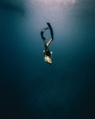 Person diving deep in Mediterranean sea