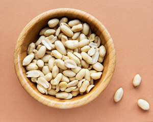 Canvas Print - Peeled peanuts in a wooden bowl