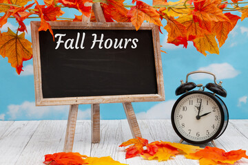 Wall Mural - Fall Hours sign with an alarm clock with standing blackboard with fall leaves