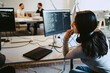© Maskot - Female hacker looking at computer while working in startup company