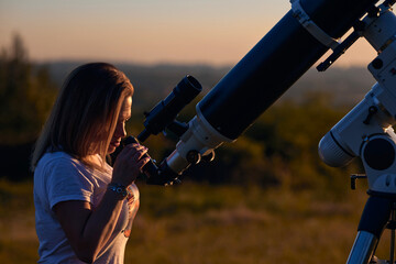 Wall Mural - Silhouette of a woman, astronomical telescope and countryside.