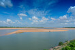 Beautiful landscape image of Mahanadi river of Odisha, with blue sky and white clouds in the background. Nature stock image of Odisha, India with copy space.