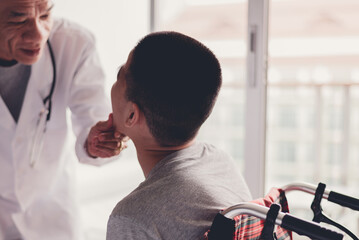 Young man with disability opening his mouth for the doctor to check the health of the mouth and teeth in examination room, Activity of people with disabilities in hospital, Healthcare concept.