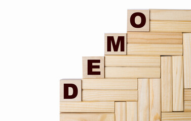 Fototapete - On a light background, wooden blocks and cubes with the text DEMO