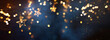 Leinwandbild Motiv Christmas warm gold garland lights over dark background with glitter overlay