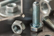 nuts, bolts, screws, washers, bearings on a metal steel background.