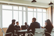 © xartproduction - Group of young business people working and communicating while sitting at the office desk together with colleagues sitting. business meeting