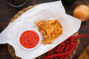 Poster - Closeup shot of spicy fried chicken, peppers, and ketchup