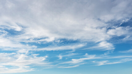 Wall Mural - wispy clouds and blue sky suitable for background