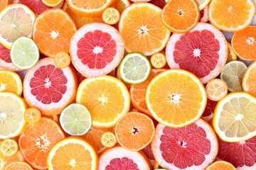 Wall Mural - Colorful bright background of fresh ripe sweet citrus fruits: orange and red grapefruit, green lime and yellow lemon, tangerine and kumquat