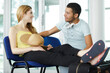 © auremar - young couple waiting in airport lounge feet on suitcase