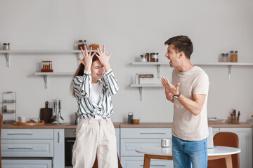 Poster - Angry young man shouting at his wife in kitchen