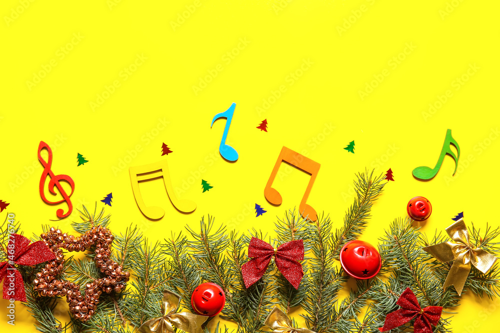 Note signs with Christmas decor and fir branches on yellow background