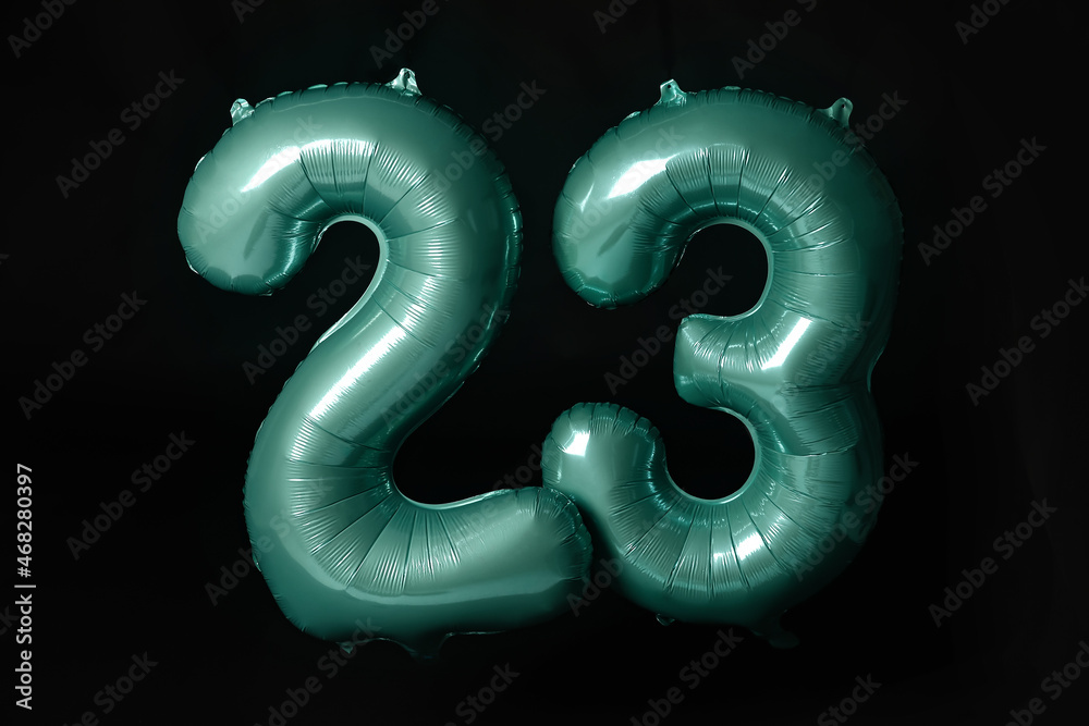 Figure 23 made of color balloons on black background